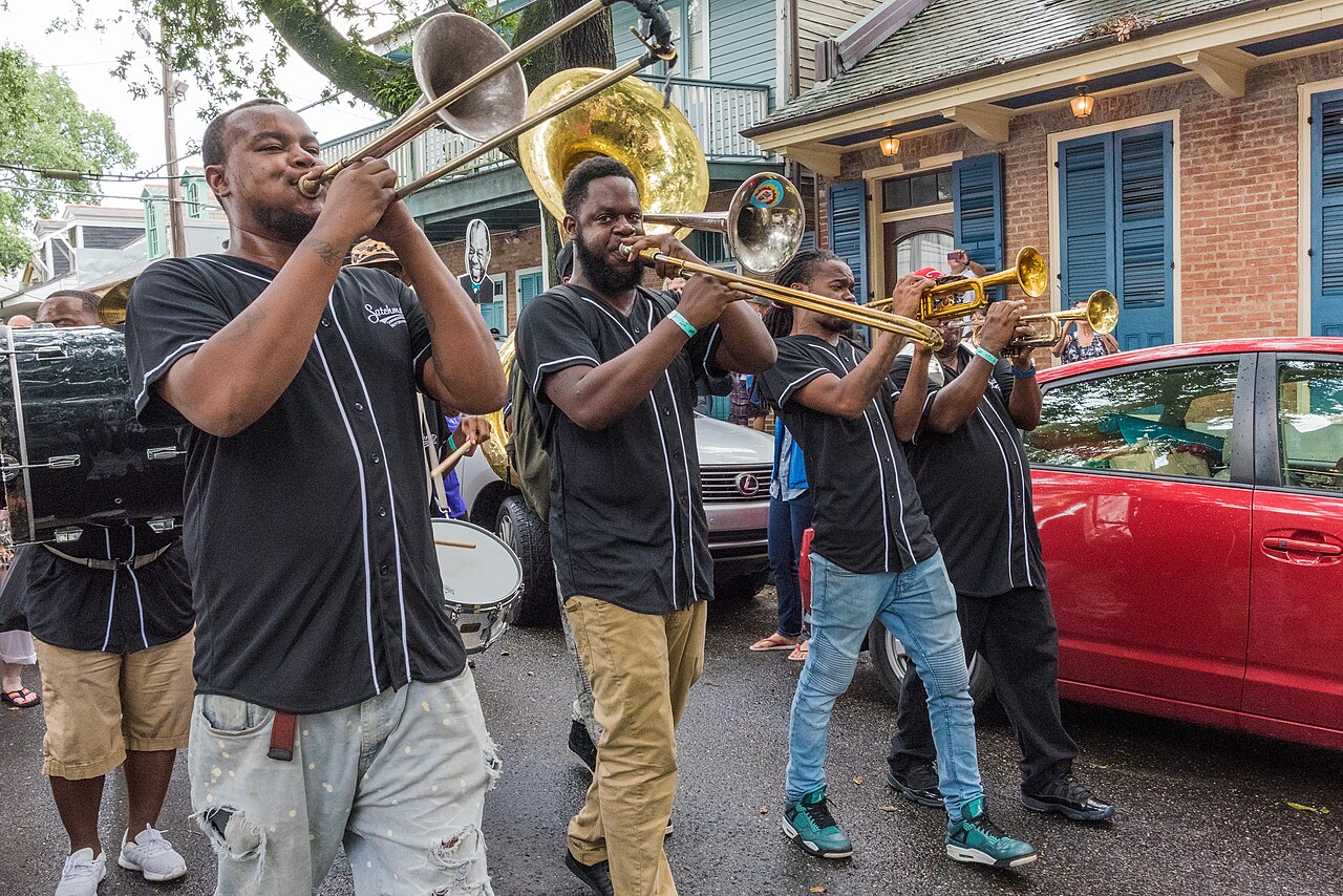 A brass band second-lines at Satchmo SummerFest in 2017. Sunday parades roll through the neighborhoods where the clubs were built.
