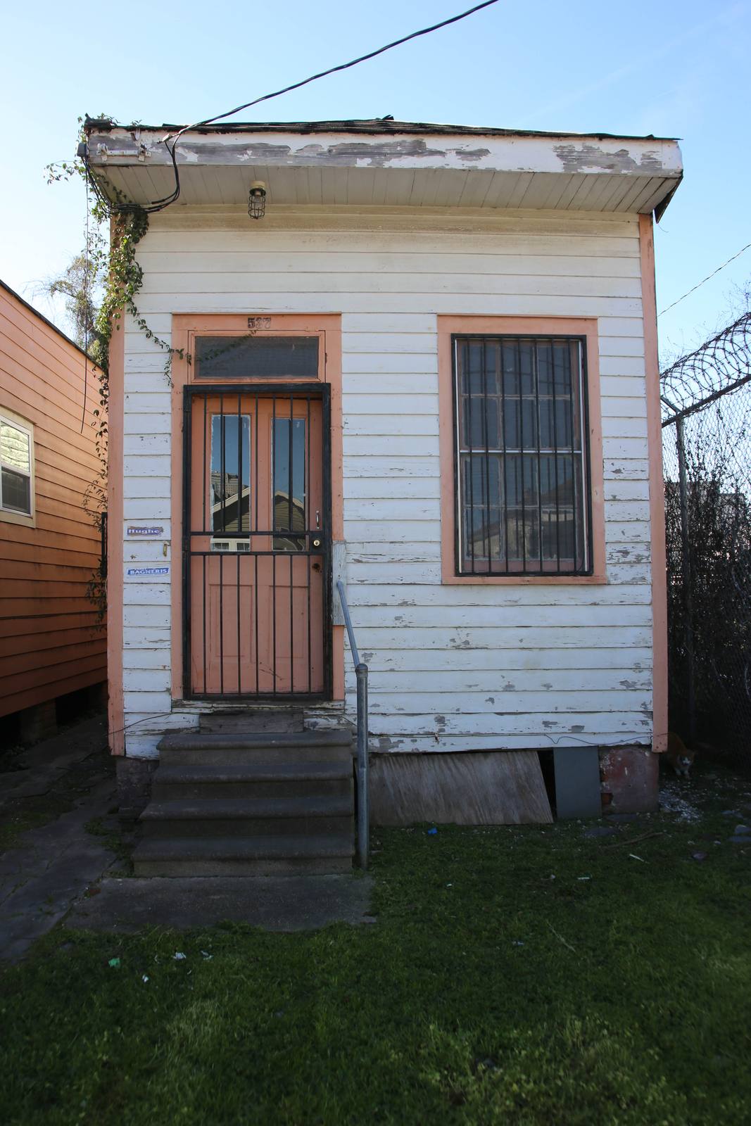 A shotgun house in Mid-City. The calculator asks for market value, property type, homestead exemption status, and land and building values to estimate the change.