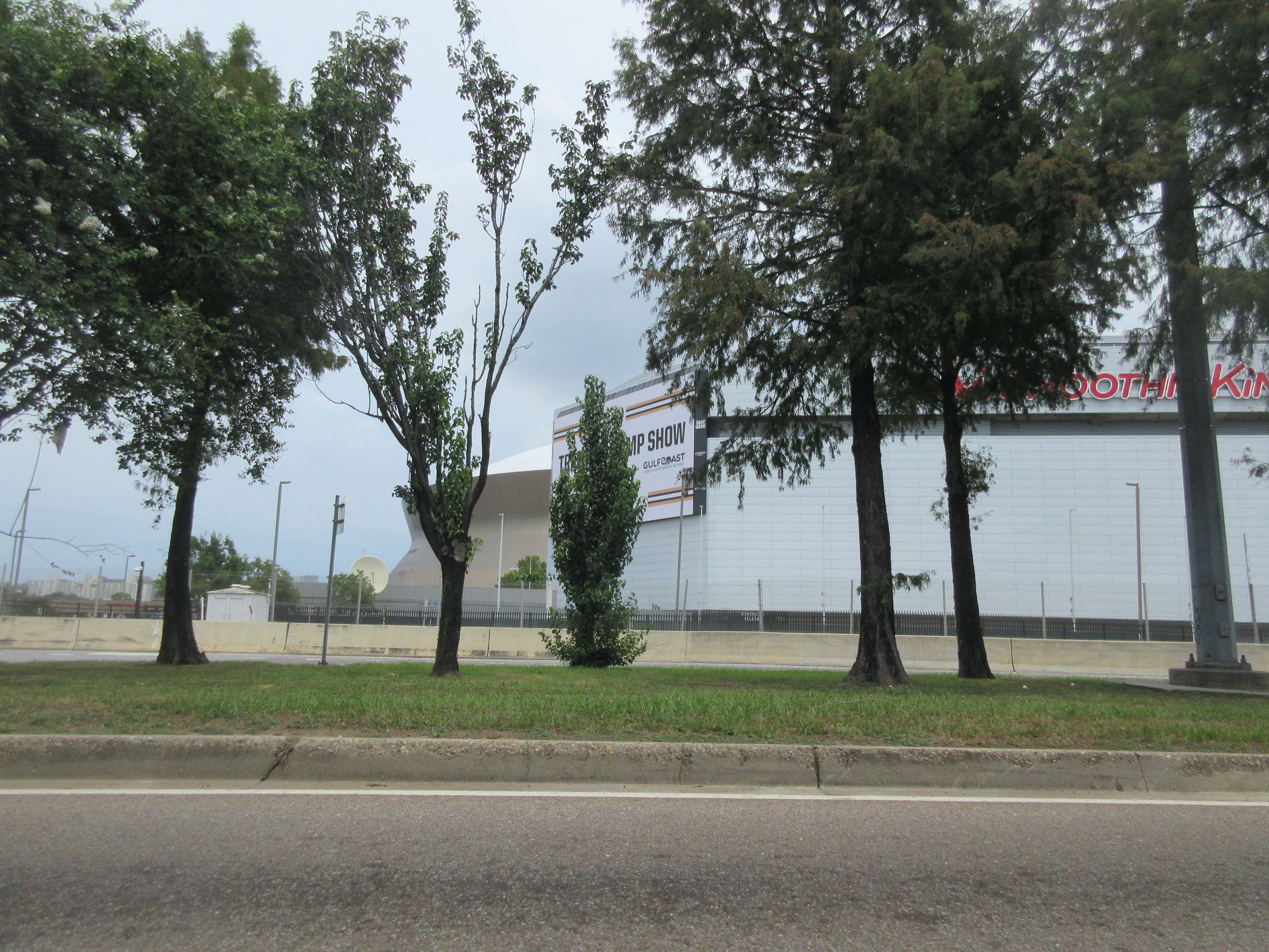 The Caesars Superdome (left, behind the Smoothie King Center signage) seen from Earhart Boulevard in August 2026.